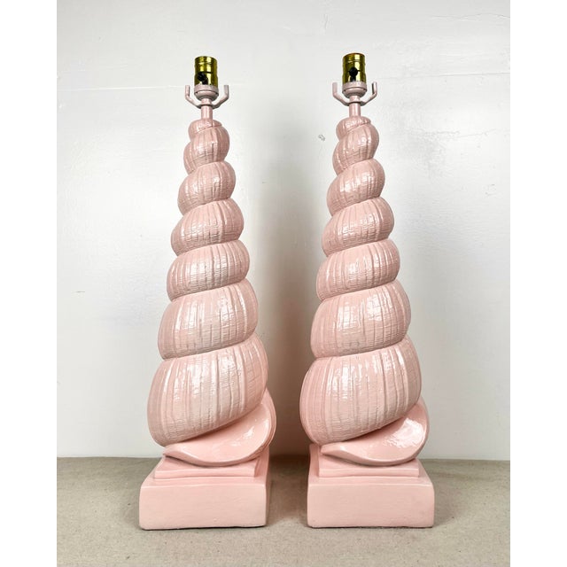 Vintage pair of tall plaster shell lamps. Newly lacquered in Benjamin Moore "Salmon Berry". Tall spiral shells in the...
