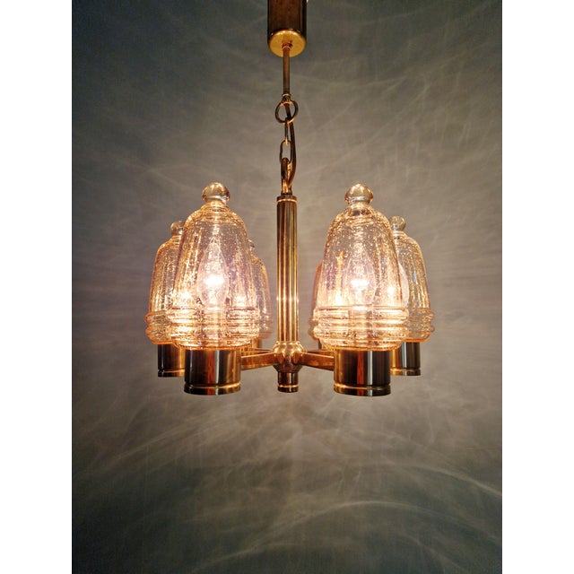 Six-arm brass chandelier with amber bubble glass globes, dating from the 1970s. Compatible with six E14 LED bulbs. Some...