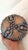 Handmade ceramic tripod bowl featuring a textured exterior with raised ribs, blue-green glazing, and a deep reddish-...