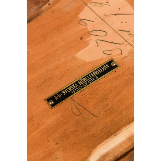 This rare side table, attributed to Carl Malmsten and produced by Bodafors in Sweden during the 1930s, exemplifies the...