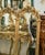 Elevate your interior with this striking French-inspired wall mirror, featuring an elaborate gold leaf frame crowned with...