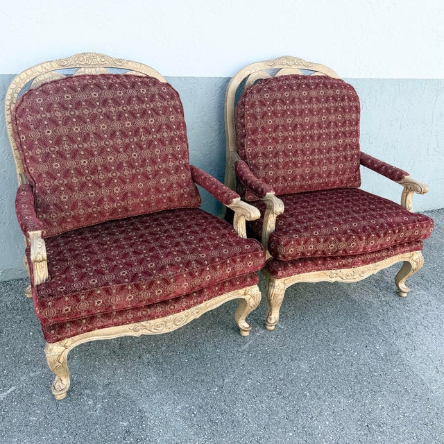 Elegant pair of vintage French Provincial armchairs inspired by classic Louis XV design. Each features an ornately carved...