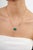 This paperclip chain solitaire necklace features a bold 9.66-carat emerald-cut natural green emerald, set horizontally in...