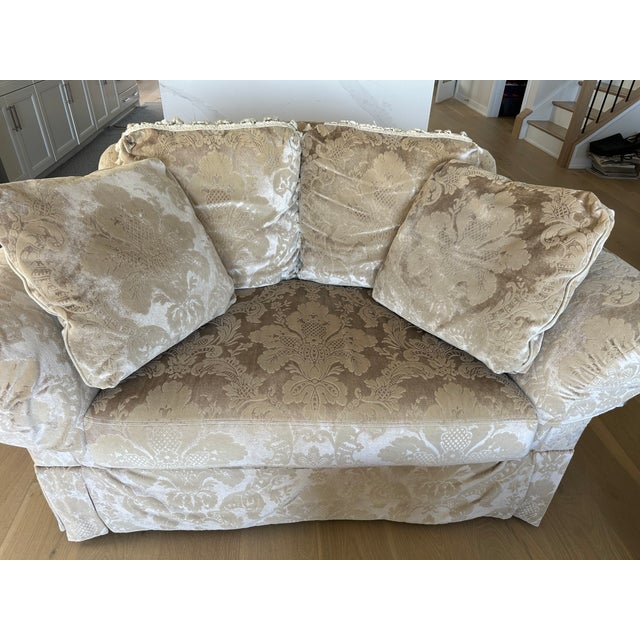 Elevate your living space with this classic camel‑back loveseat from Vanguard, a brand known for exceptional craftsmanship...