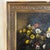 Striking antique oil painting on canvas of flowers in a vase, signed Mabel.B Messer and presented in the original wood frame.