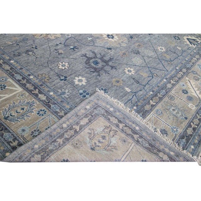 Beautiful modern Oushak hand-knotted wool rug with a gray field. This Oushak rug has a beige designed frame and blue...