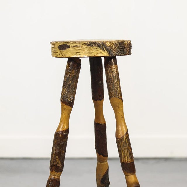 This rustic wooden side table is a beautiful example of folk art from the 1970s. The table is made from rough pieces of...
