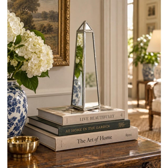 A beautifully proportioned contemporary mirrored neoclassical style obelisk. The sculptural silhouette gives the piece a...