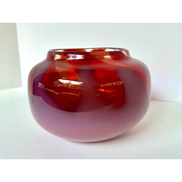 This luminous hand-blown art glass vase captivates with its rich ruby hues and seamless ombré into soft milky rose. The...