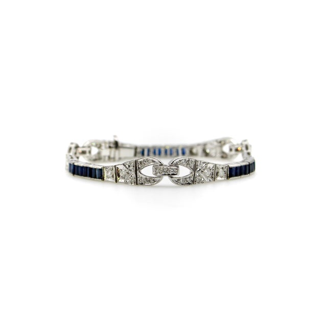 This beautiful 18k white gold bracelet features design elements from the Art Deco era. The classic diamond and sapphire...
