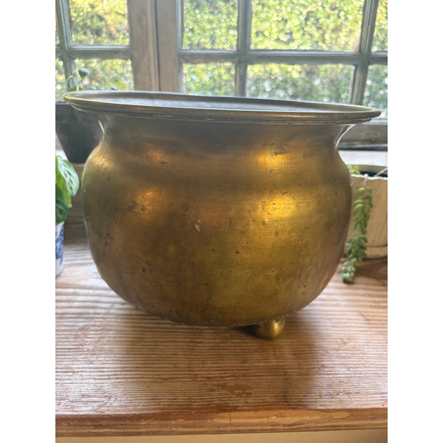 This early 20th-century brass bowl was hand-formed in an Indian workshop, its surface still showing every hammer strike...