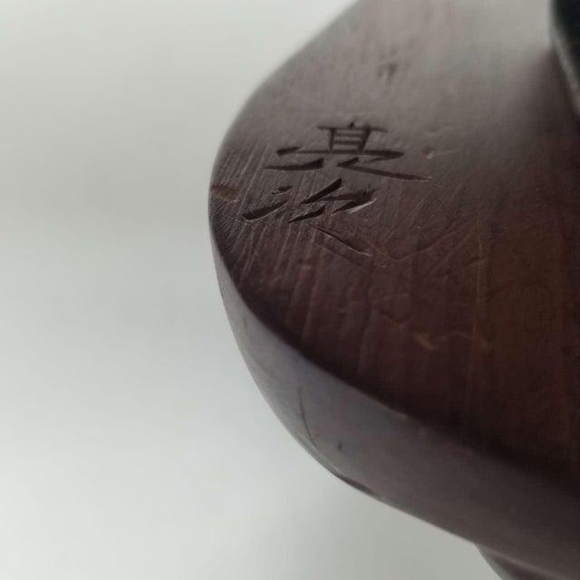 This is a vintage Japanese wall-mounted display featuring three finely carved wooden Noh-style masks, each depicting a...