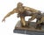 Art Deco style bronze figurine depicting a dynamic scene of a male figure controlling a team of running dogs. Cast in...
