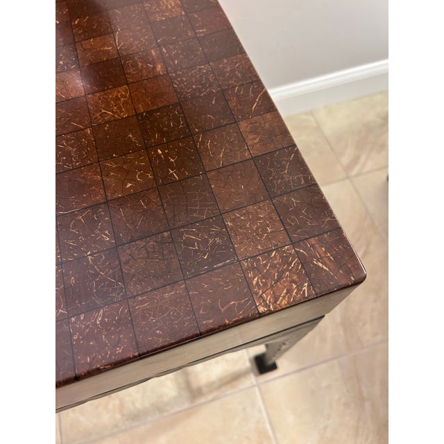 Creativity abounds when using this unique desk encased in a coconut shell mosaic. Chocolate calf leather top. single...