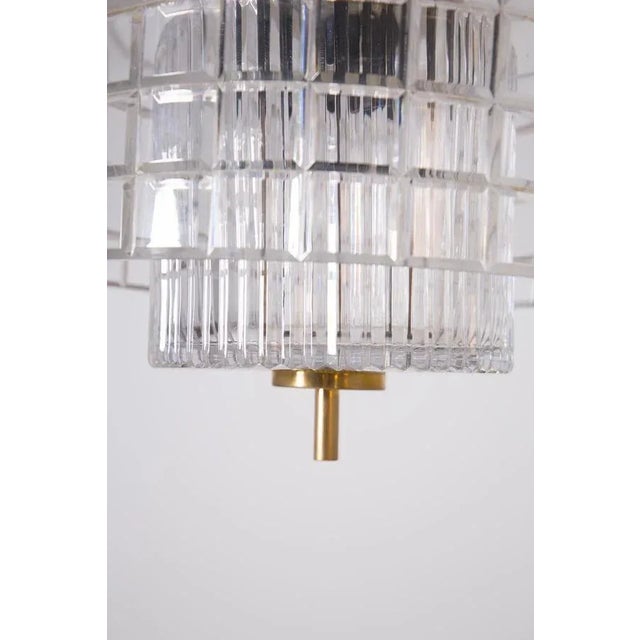 Beautiful 1960s brass and Bohemia crystal chandelier. The chandelier has a brass frame, its circular shaped shade has been...