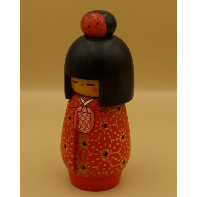 A signed Japanese sosaku (creative) kokeshi by Kazuo Takamizawa, executed in turned and hand-painted wood. This mid-...