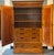 Impressive traditional armoire featuring a warm, rich wood finish and beautifully figured wood-grain panels. The...