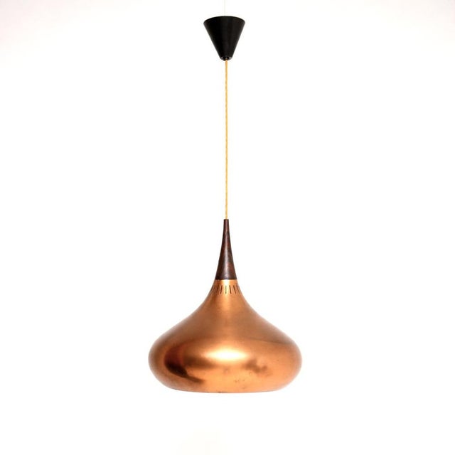 A stylish and iconic original vintage Danish copper and wood Orient pendant lamp by Jo Hammerborg. This was made by Fog...
