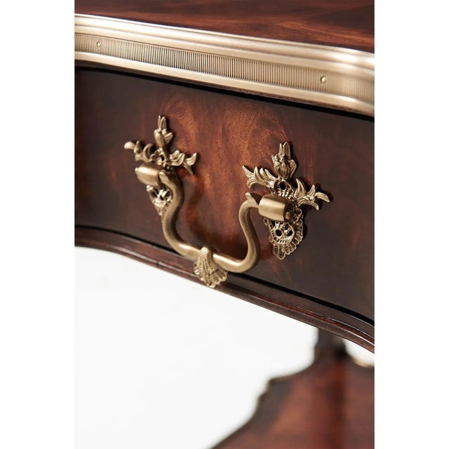 A Louis XVI style mahogany veneer end table, the serpentine square brass bound top above a shaped frieze drawer with...