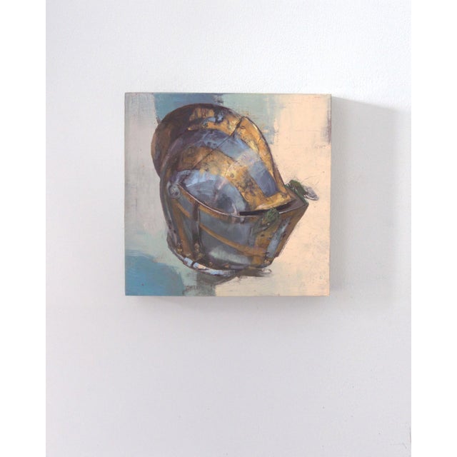 This oil on panel artwork presents a striking depiction of a knight's helmet, rendered with a blend of metallic tones that...