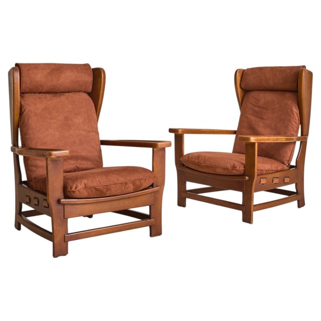 A 1960s Italian armchair attributed to Percival Lafer, defined by its architectural wooden frame and softly contoured...
