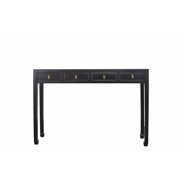 This vintage wooden console table features four side-by-side storage drawers, each detailed with a traditional metal ring...