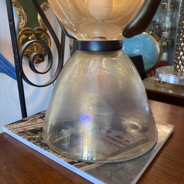 Pair of iridescent Murano glass table lamps. Shaped like a large Murano glass, with curved handles in iridescent black....