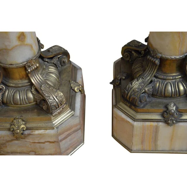 Matched pair of exquisite xixth century onyx pedestals each with revolving top with ormolu collar below, substantial...