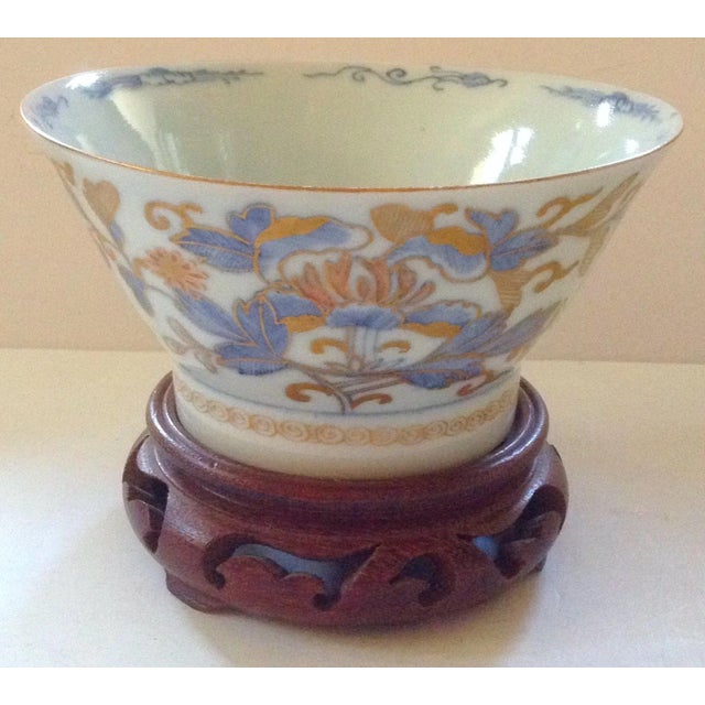 Antique 19th c. Chinese export porcelain bowl on rosewood stand. Decorated in famille bleu with gold accents. Bottom of...