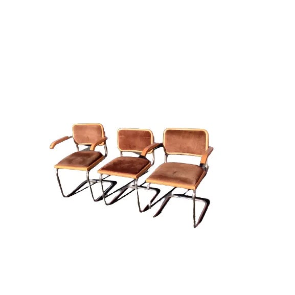 A set of 3 Faux suede Cesca Style armchairs attributed to Marcel Breuer. Made in Italy, circa 1970s. The chairs feature a...