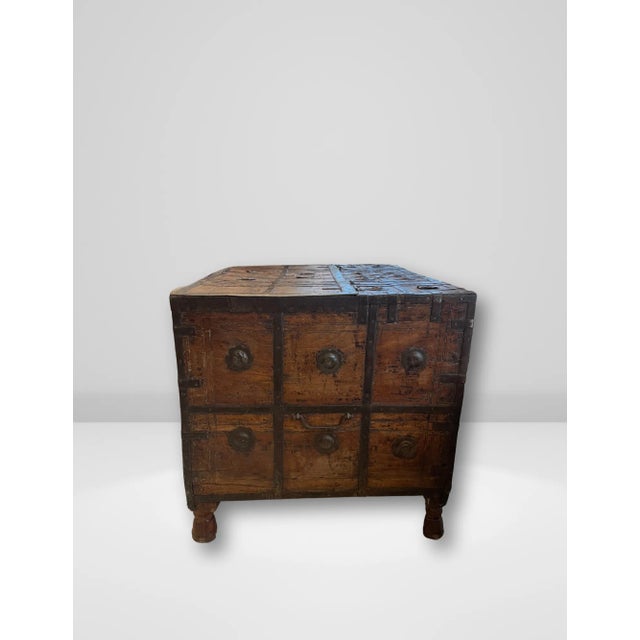 This striking antique Indian dowry trunk is expertly crafted from hand-carved wood and accented with decorative metal...