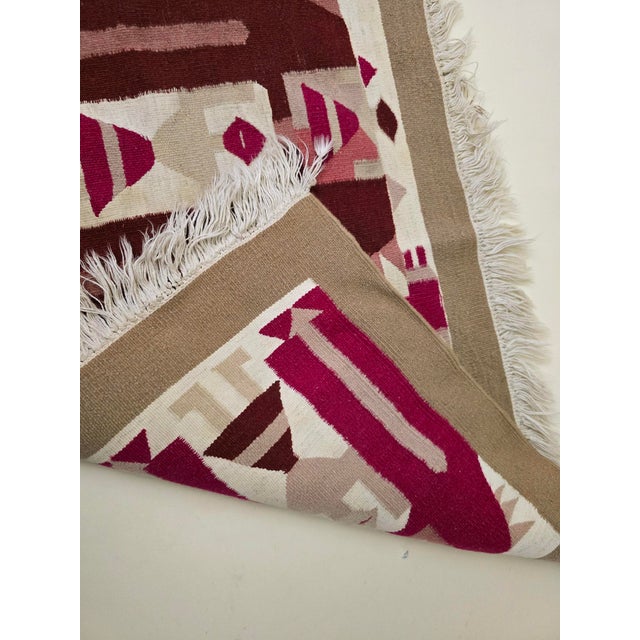 This exquisite vintage kilim is a handmade Tunisian Berber textile from the 1960s, showcasing the rich cultural artistry...