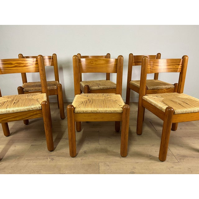 Set of 6 solid oak chairs with woven straw seats, designed by Charlotte Perriand in the 1960s. The chairs have been...