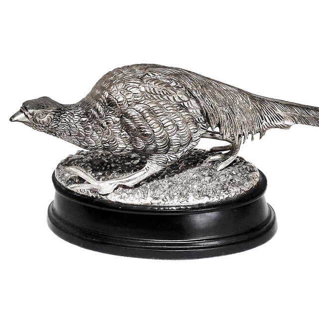 Victorian silver plate pheasant intricately designed featuring textured plumage and a long, sweeping tail. Mounted on an...