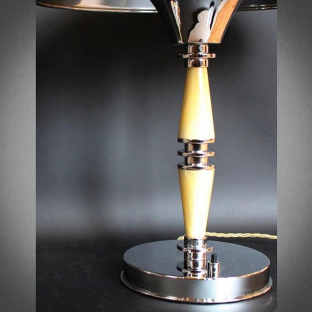 A pair of art deco dome lamps with sectioned, pale golden bakelite and chromed metal stems. Bakelite finial to top. Fully...
