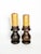 An elegant pair of solid turned-wood candlesticks featuring a beautiful dark brown patina that highlights the wood's...