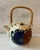 Vintage ceramic tea pot with a hand painted floral design in cobalt blue and red and a rattan wrapped handle. Made in...