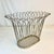 This is a wonderfully designed vintage wastebasket. The design has curled over crown points crafted by a metal wire along...