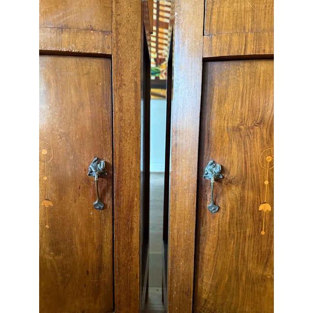 Beautiful pair of antique Art Nouveau nightstands with original marble tops, delicate inlay, and sculptural brass...