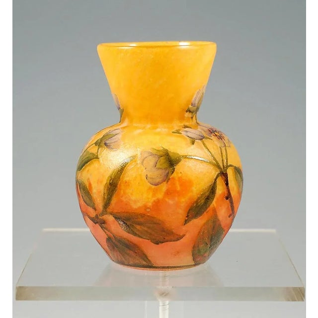 Small baluster vase, flush round stand, bulbous body with attached funnel-shaped neck, colorless glass with color powder...