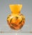 Small baluster vase, flush round stand, bulbous body with attached funnel-shaped neck, colorless glass with color powder...