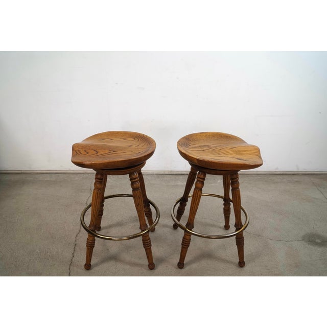 Drexel 1970’s Solid Oak & Brass Tractor Swivel Counter Stools - A Pair For Sale - Image 4 of 12