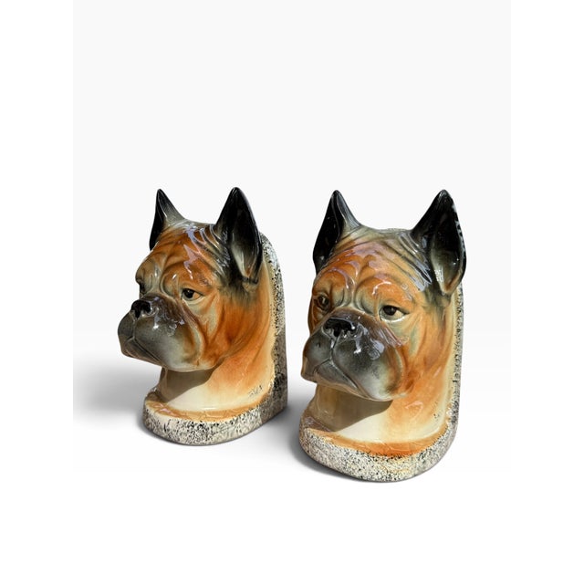 A charming pair of mid-century ceramic busts, likely from the 1950s or 1960s, featuring sculpted boxer dog heads with...
