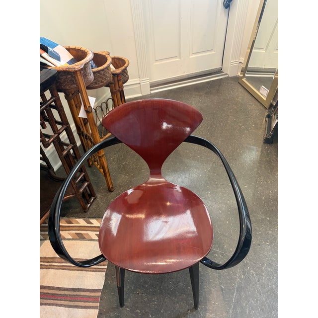 Striking pair of Cherner-style Pretzel armchairs featuring sculptural bentwood arms, molded plywood seats and backs, and...