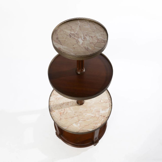 A high-quality three tiered accent/dessert/pastry table with two tiers of marble. The reeded columns, brass galleries, and...