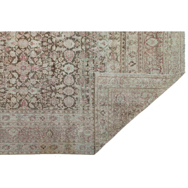 Masterfully hand-knotted, this exquisite piece features a beautifully weathered all-over botanical design. Characterized...