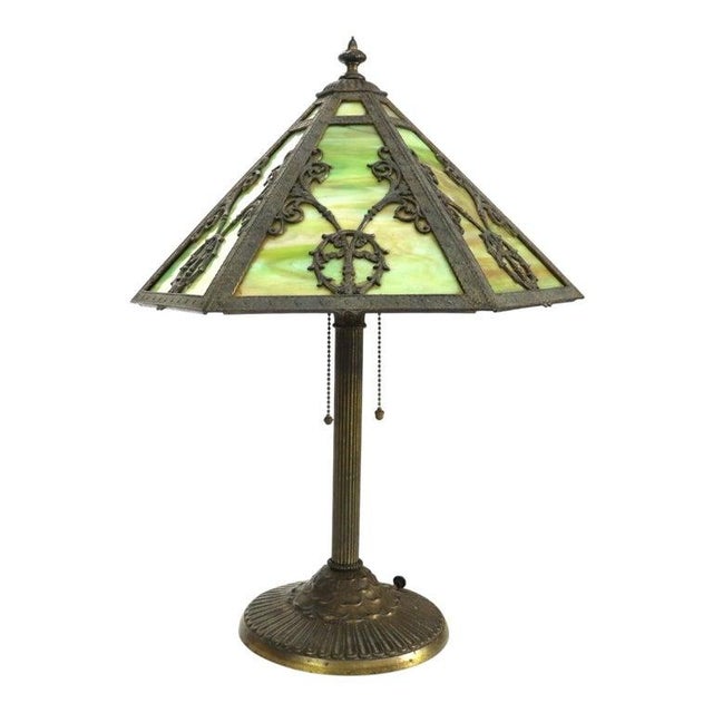 An antique Rainaud table lamp, crafted in the Bradley & Hubbard style, dating to approximately 1920. This lamp features a...