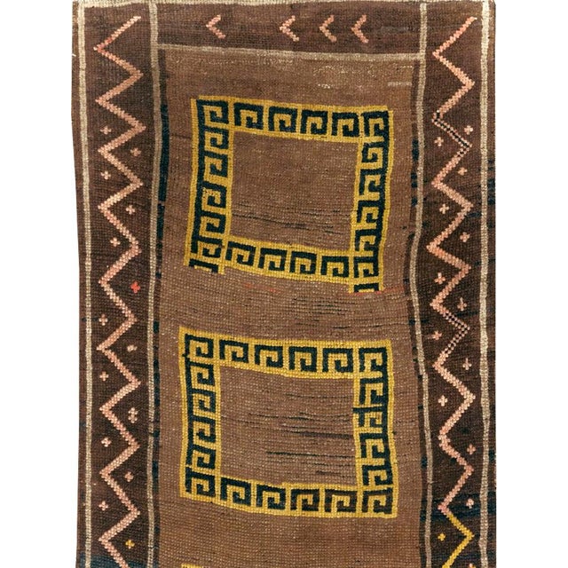 This mid-20th-century Turkish Anatolian tribal runner presents a striking sequence of eight open rectangular compartments...
