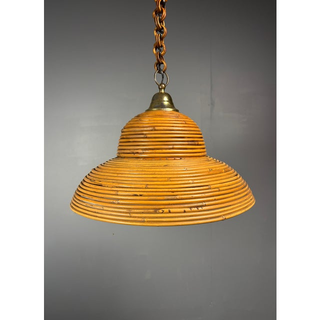 Lovely pencil reed or split reed rattan pendant, Italy, 1970s. This rare bell shaped hanging lamp is in great vintage...