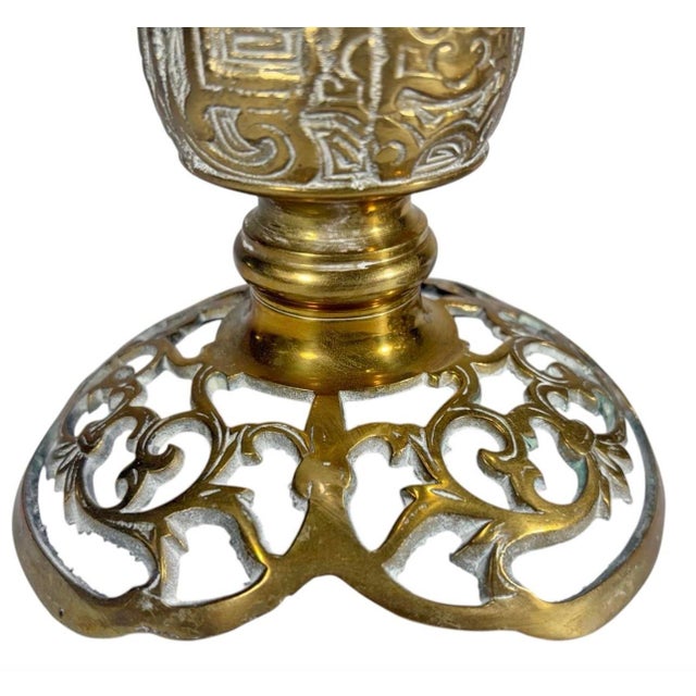 Asian style, pair of cast brass candle holders with openwork bases, pierced drip pans, and decorative relief motifs, mid...